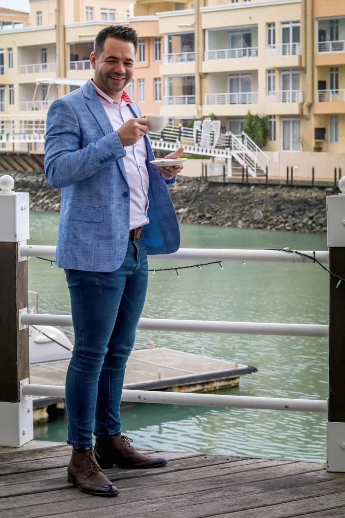 Peter Groenenstein enjoying a coffee on a marina boardwalk