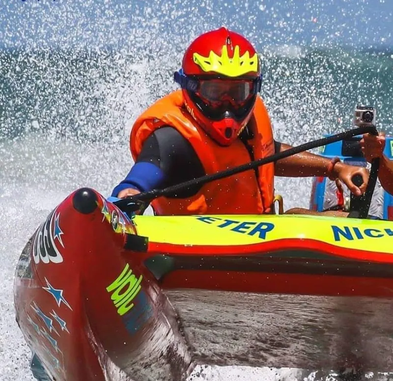 Red inflatable racing boat at speed